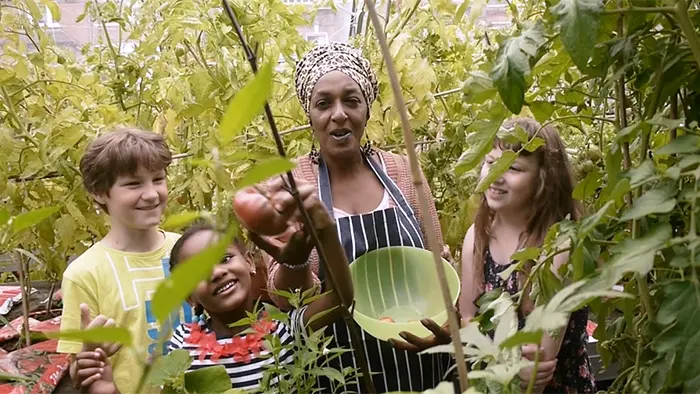 Lady and children apple picking at a crowdfunded community event