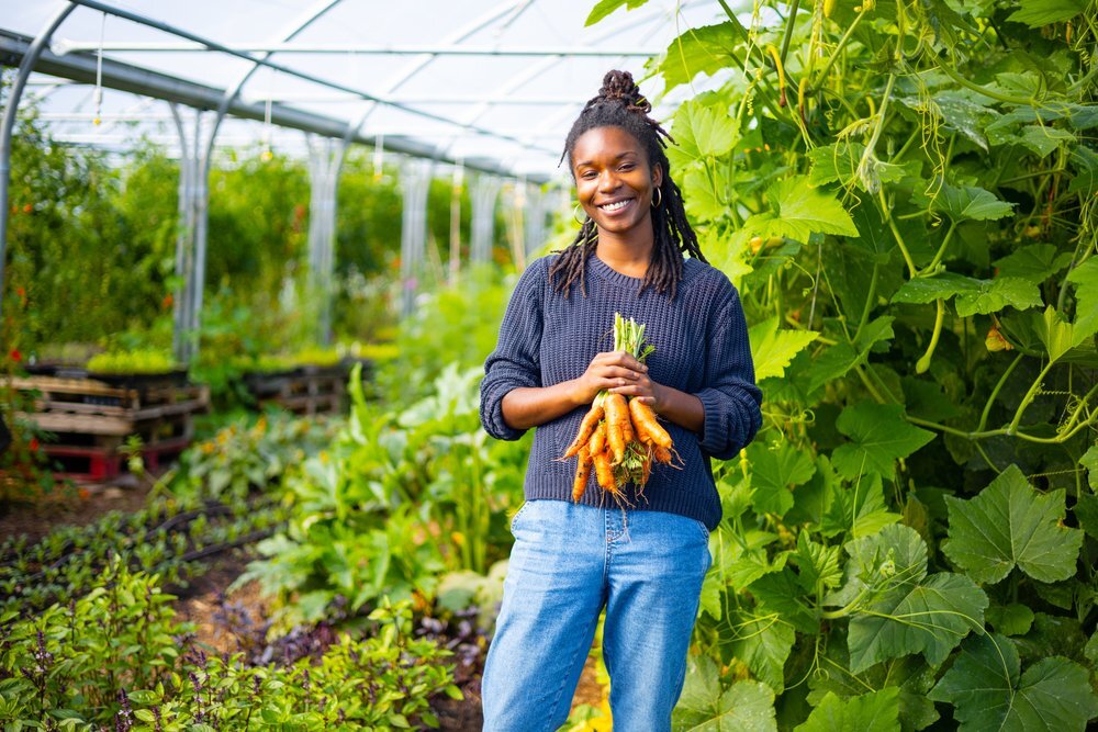 Woman holding vegetables on a community farm 