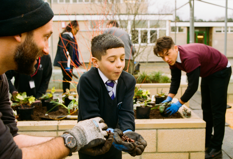 School boy growing food in local community