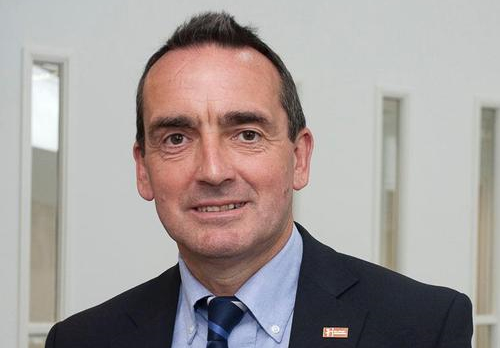 Headshot of man in suit and tie