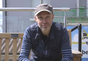 Headshot of man wearing baseball cap